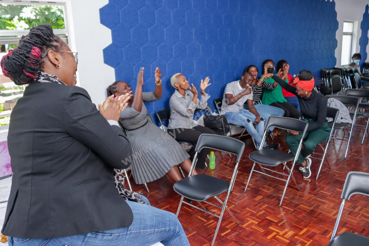 Engaged team participating and applauding in a corporate workshop