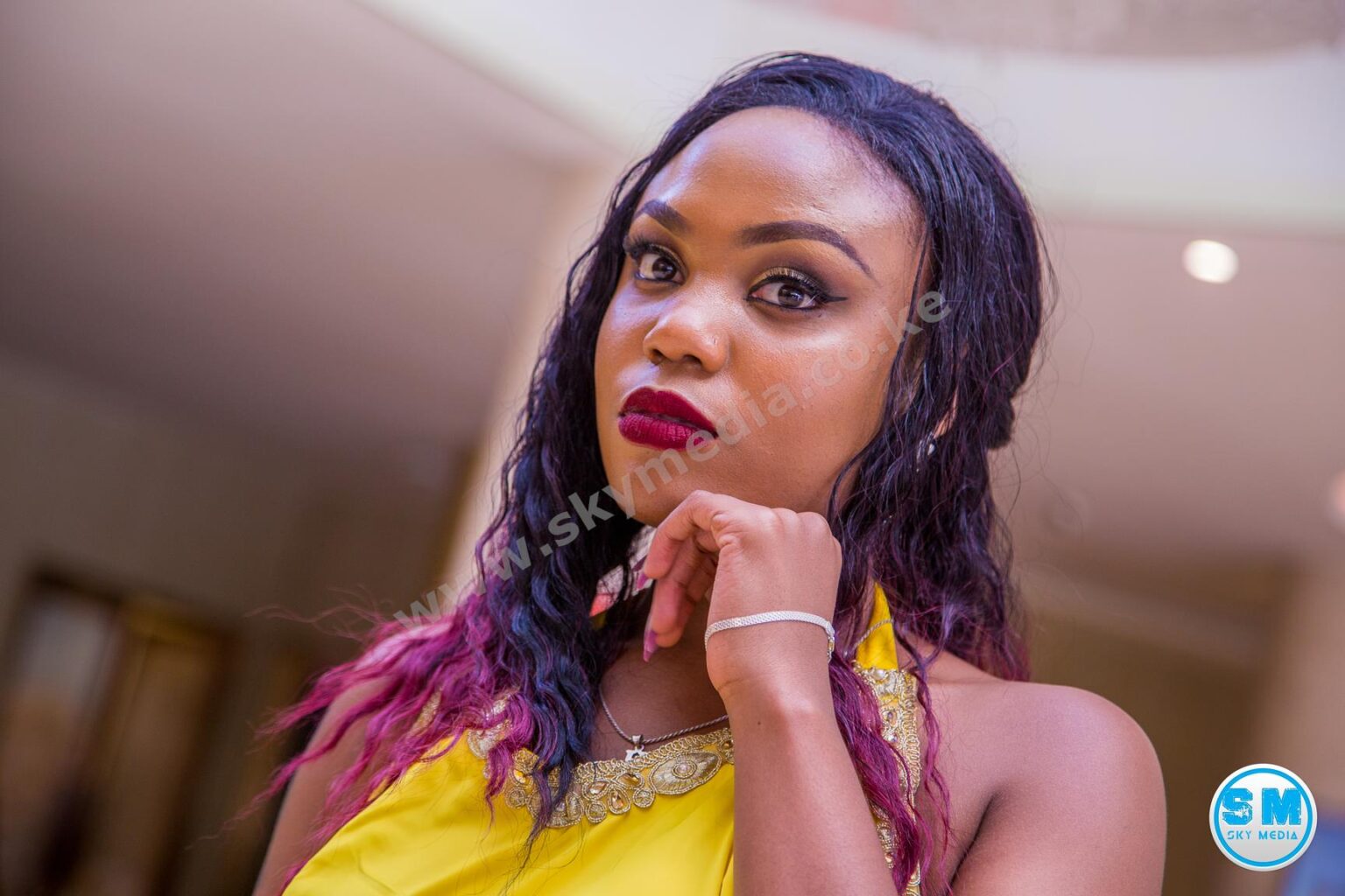 Glamour portrait of a woman with striking makeup wearing a yellow top